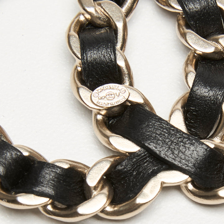 Pre-Loved Chanel™ Gold-Tone Interlaced Black Calf Leather Logo Brooch