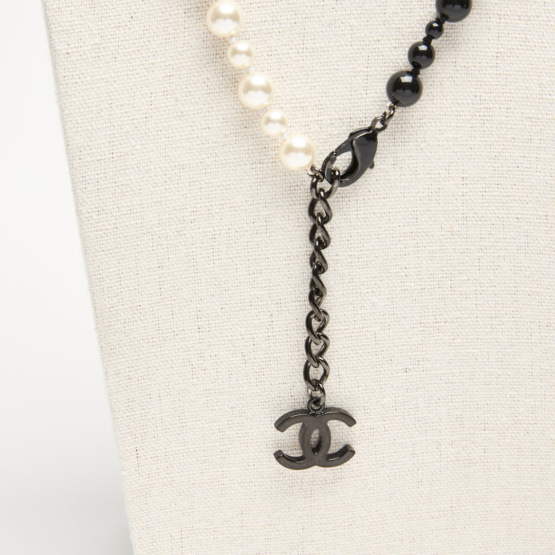 Pre-Loved Chanel™ Black & White Faux Pearl Necklace with Logo Detail
