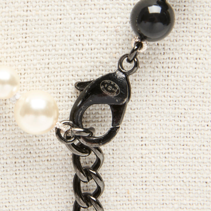 Pre-Loved Chanel™ Black & White Faux Pearl Necklace with Logo Detail