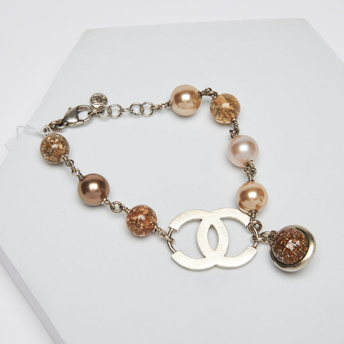 Pre-Loved Yellow Tinted Resin Bead with Gold Flakes and Pearl Necklace with Logo. (front)