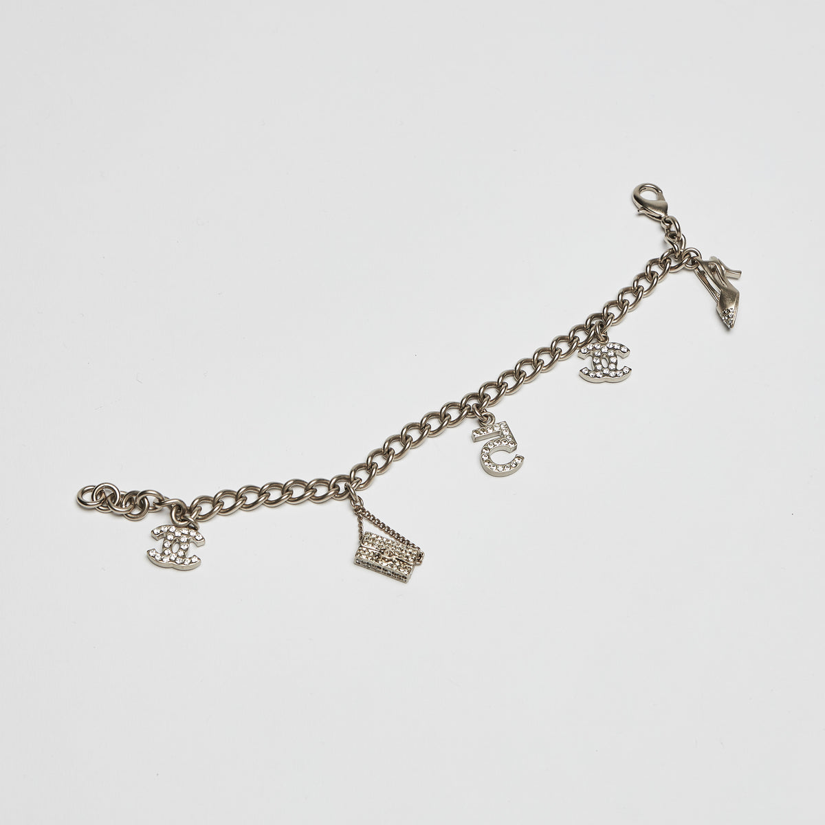 Excellent Pre-Loved Aged Champagne Gold Tone Chain Bracelet with Crystal Embellished iconic Charms.(front)