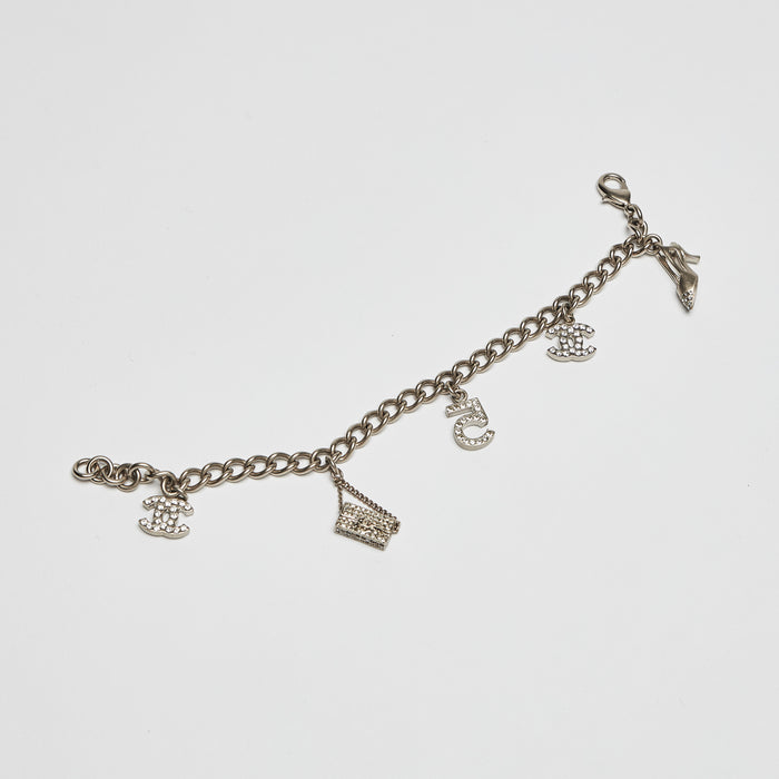 Excellent Pre-Loved Aged Champagne Gold Tone Chain Bracelet with Crystal Embellished iconic Charms.(front)