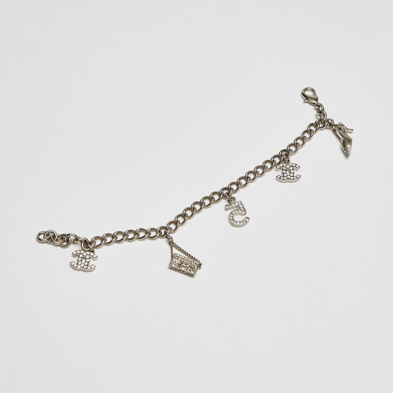 Excellent Pre-Loved Aged Champagne Gold Tone Chain Bracelet with Crystal Embellished iconic Charms.(front)