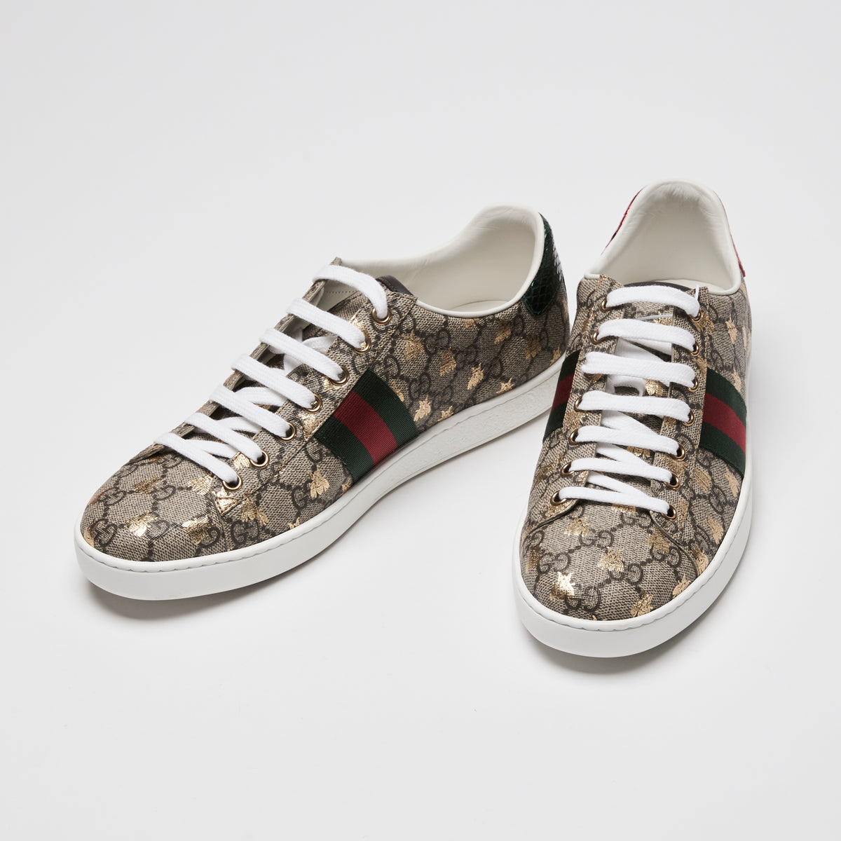 Pair of Gucci Ace sneakers in GG supreme canvas with gold printed bee motif, green and red web 