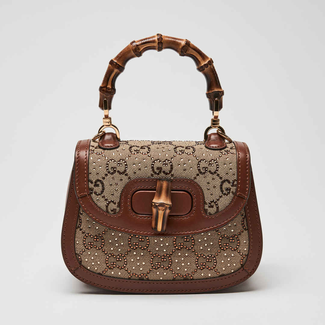 Designer Gucci handbag with bamboo handle with GG monogram crystals on canvas
