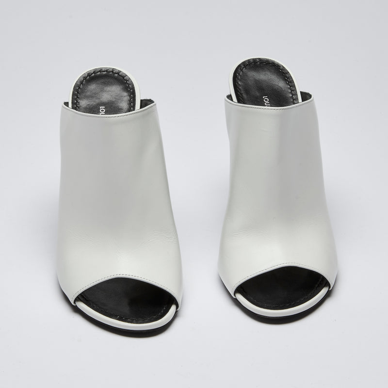 Excellent Pre-Loved White Leather and Black Enameled Block Heel Peep Toe Mules with Oversized Logo Etched on Backside of Heels. (Front)