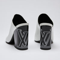 Excellent Pre-Loved White Leather and Black Enameled Block Heel Peep Toe Mules with Oversized Logo Etched on Backside of Heels. (back)