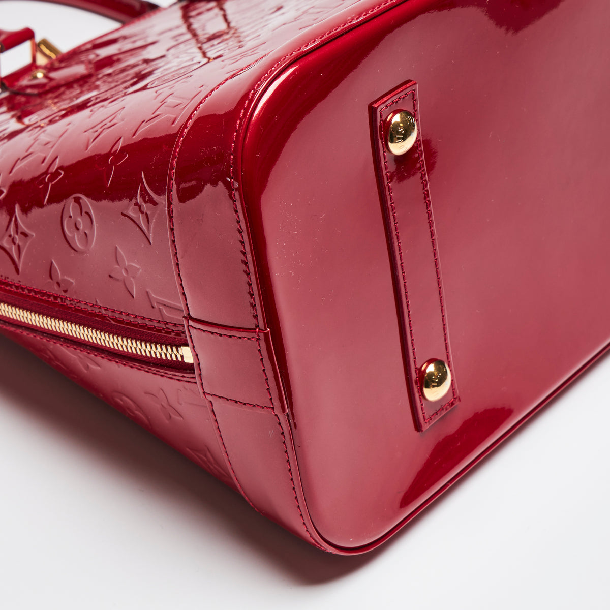 Pre-Loved Large Monogram Embossed Red Patent Leather Half Dome Shaped Top Handle Bag. (corner)