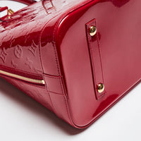 Pre-Loved Large Monogram Embossed Red Patent Leather Half Dome Shaped Top Handle Bag. (corner)