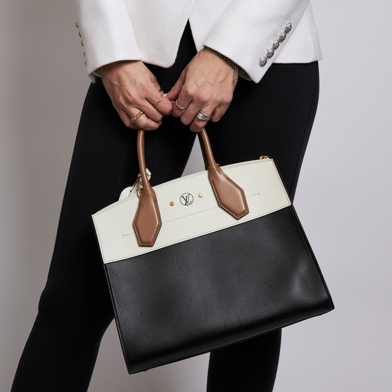 Excellent Pre-Loved Ivory/Dark Beige/Black Smooth Leather Top Handle Bag. (on body)