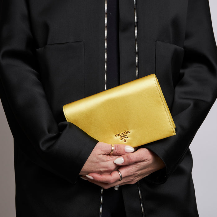 Pre-Loved Yellow Satin Clutch. (on model)