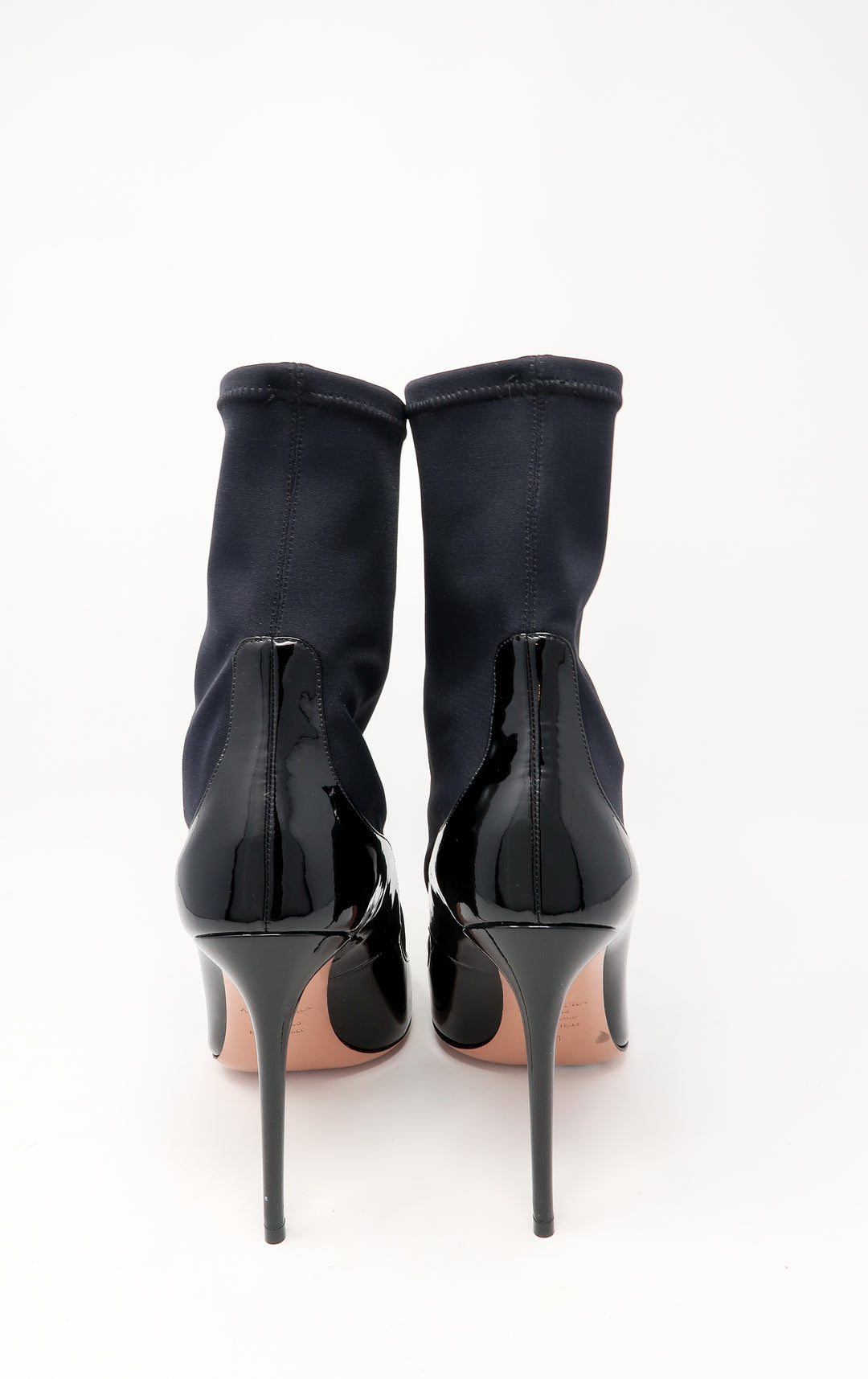 black patent leather heels with black nylon ankle socket attachment (back view)